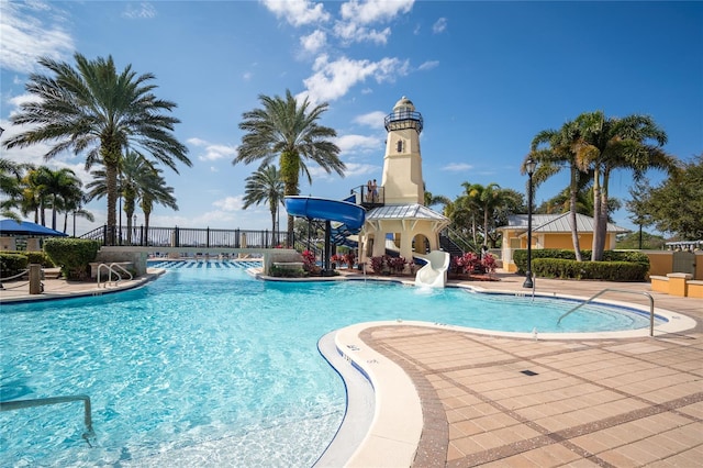 view of pool with a patio area and a water slide