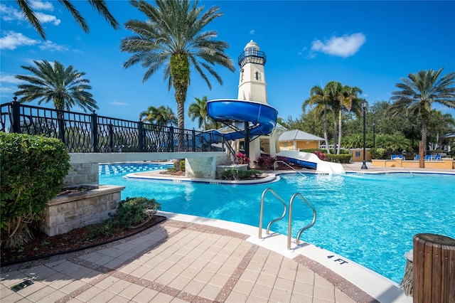 view of swimming pool featuring a patio area and a water slide