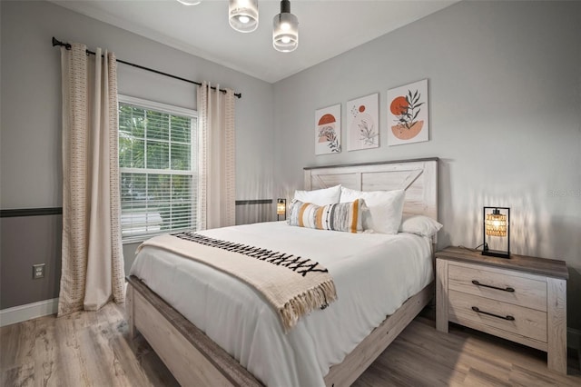 bedroom with hardwood / wood-style flooring