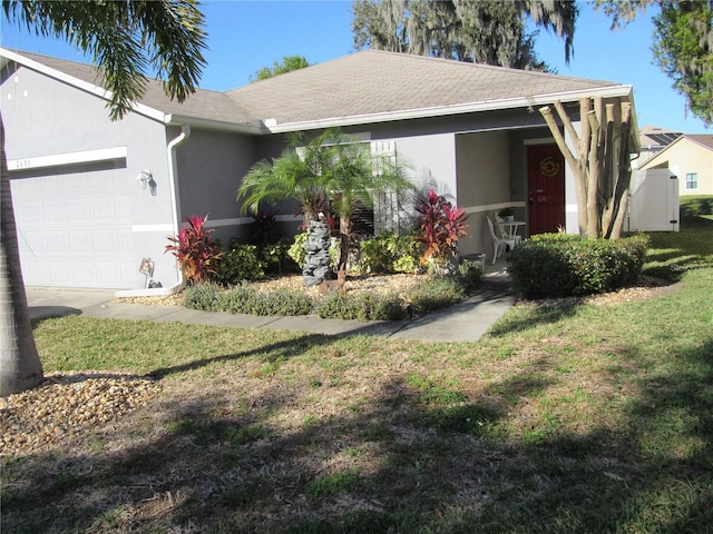 ranch-style house featuring a garage and a front yard