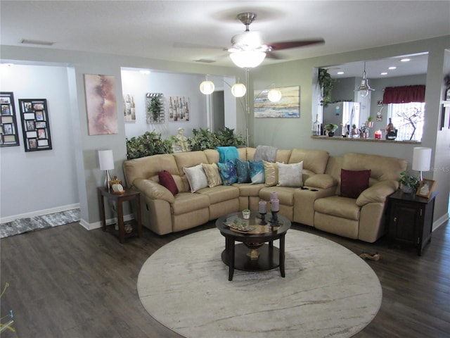 living room with ceiling fan and dark hardwood / wood-style flooring