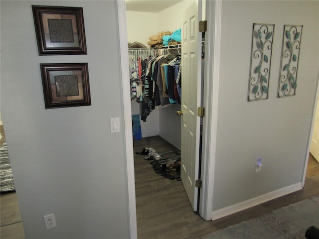 hallway with dark hardwood / wood-style floors