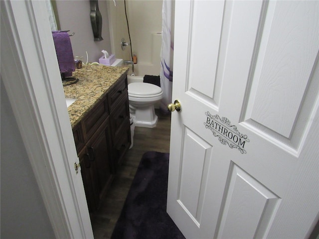 full bathroom with vanity, hardwood / wood-style flooring, shower / bath combination with curtain, and toilet