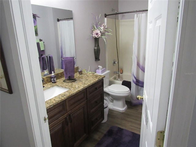 full bathroom with vanity, hardwood / wood-style floors, shower / tub combo, and toilet