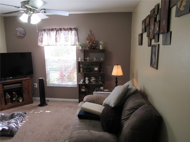 carpeted living room with ceiling fan