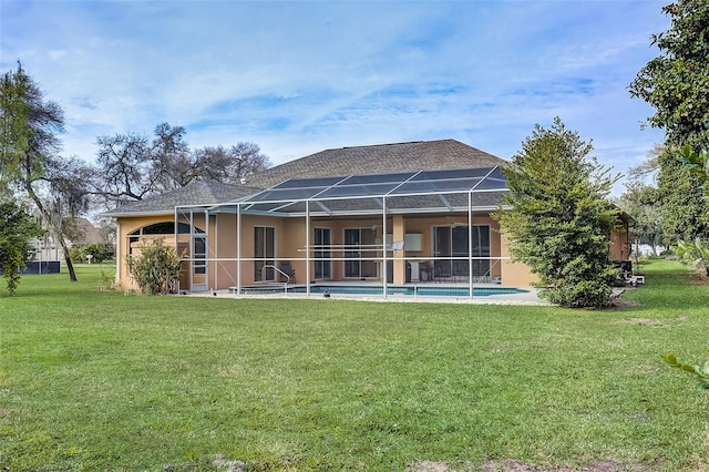 rear view of property featuring a yard and glass enclosure