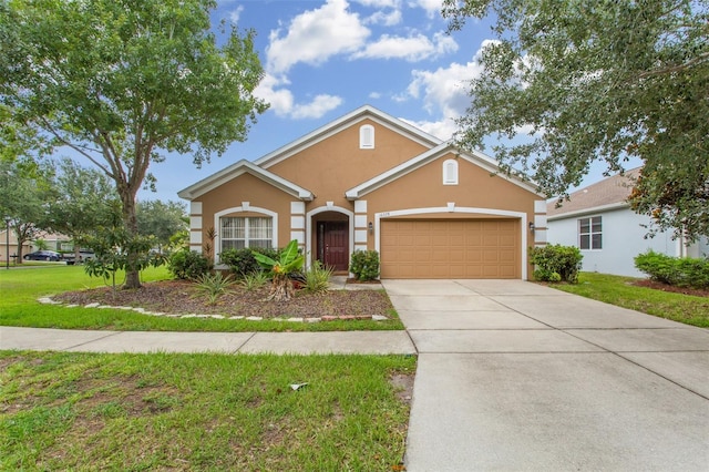 view of front of home with a garage and a front lawn