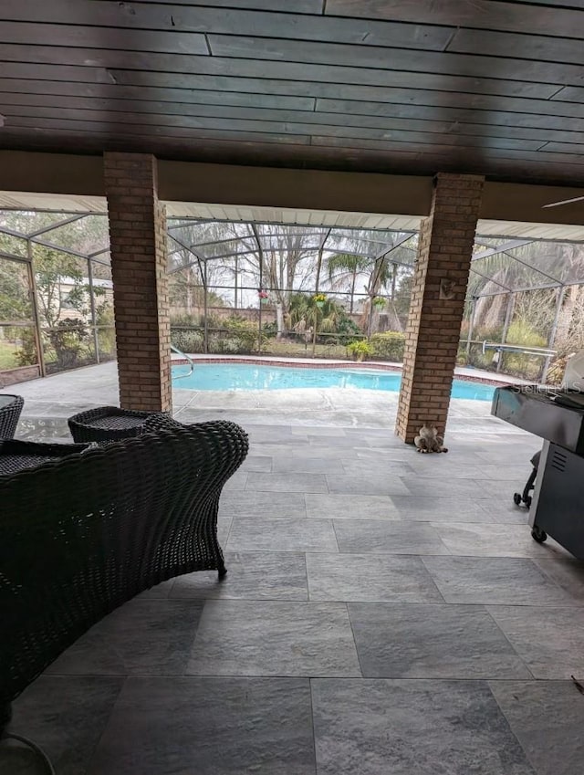 view of pool with a patio area and a lanai