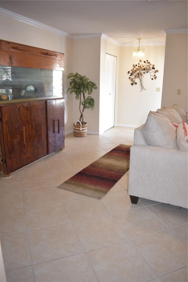 living room with crown molding, a notable chandelier, and light tile floors