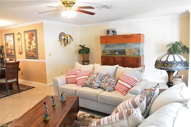 living room with a textured ceiling, ornamental molding, light tile flooring, and ceiling fan