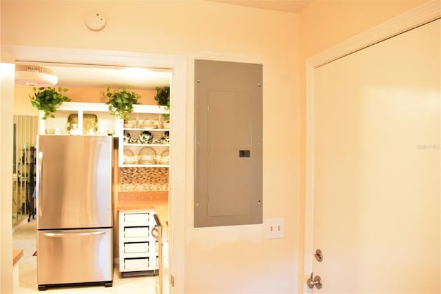 kitchen featuring stainless steel fridge and light tile floors