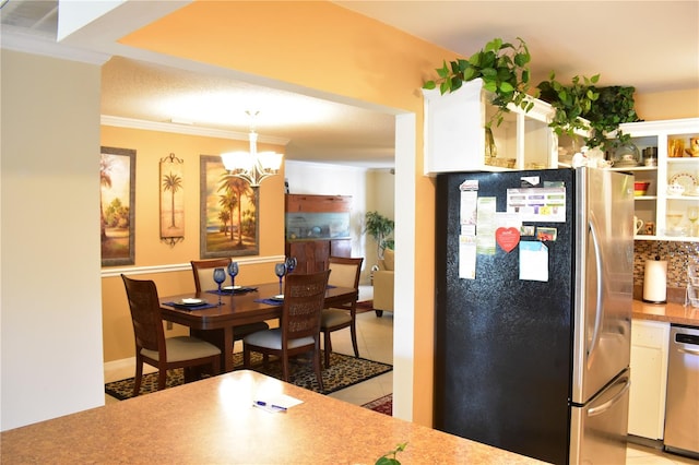 dining area with light tile floors, ornamental molding, and a notable chandelier