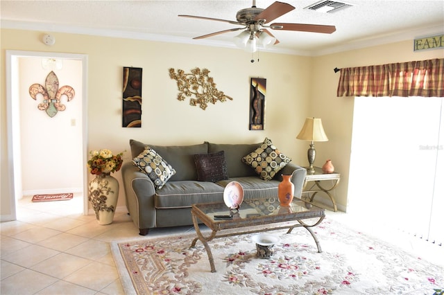 living room with ceiling fan, light tile floors, a textured ceiling, and crown molding