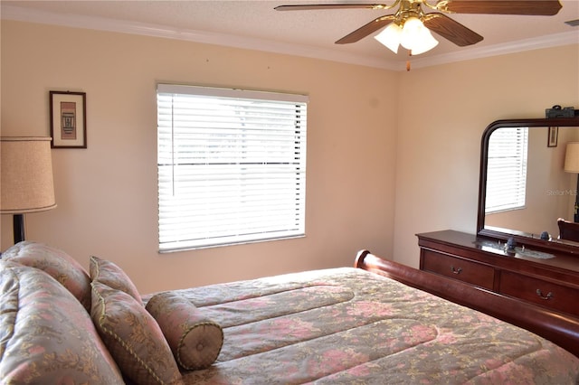 bedroom with ornamental molding, ceiling fan, and multiple windows