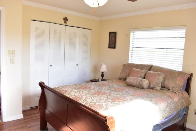 bedroom featuring a closet, hardwood / wood-style floors, and crown molding