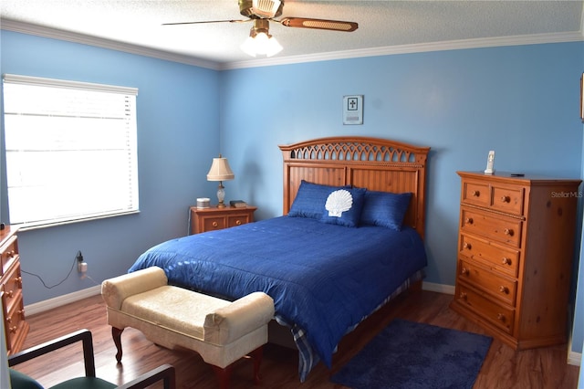 bedroom featuring ornamental molding, a textured ceiling, ceiling fan, and dark wood-type flooring