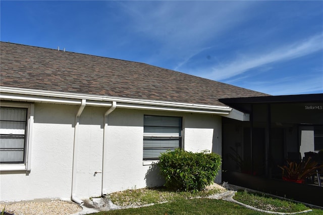 view of side of property featuring a sunroom