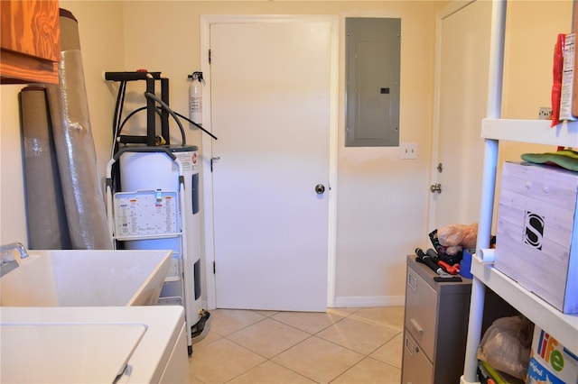 clothes washing area with sink and light tile floors