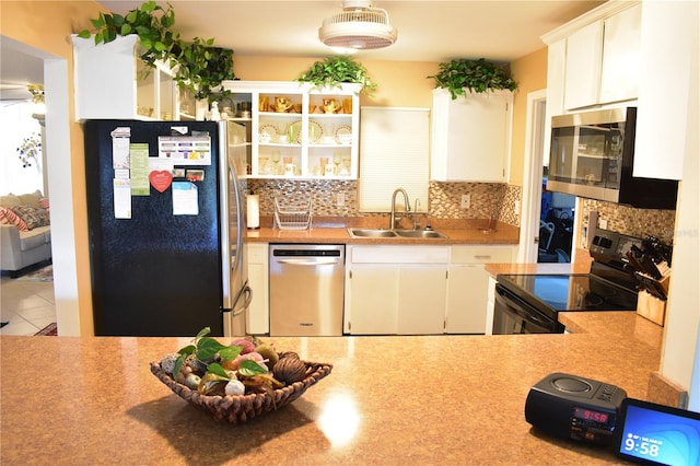 kitchen with white cabinets, tasteful backsplash, appliances with stainless steel finishes, and sink