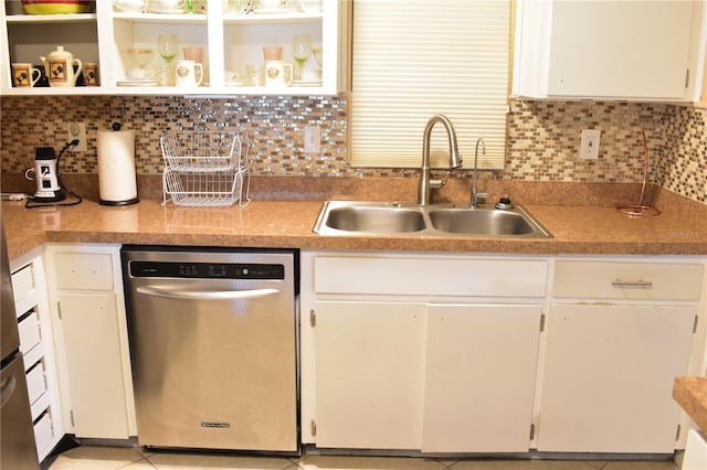 kitchen featuring white cabinets, stainless steel dishwasher, tasteful backsplash, and sink