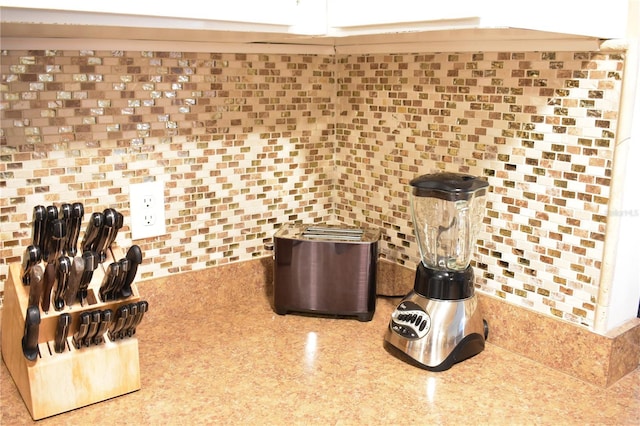 interior space with backsplash and light stone counters