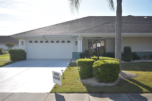 ranch-style house with a front yard and a garage