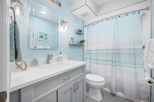 bathroom with oversized vanity, toilet, and tile flooring