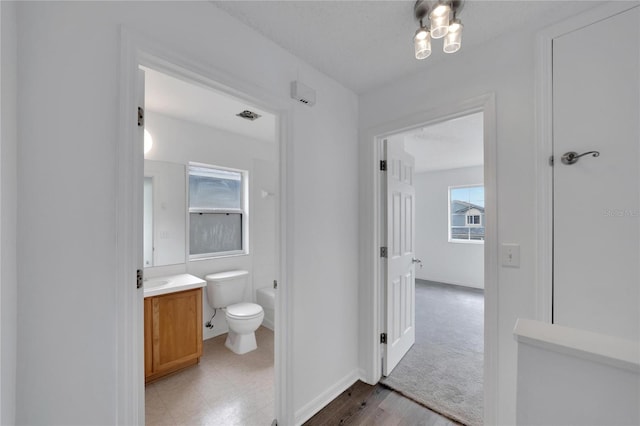 bathroom featuring tile patterned flooring, toilet, and vanity