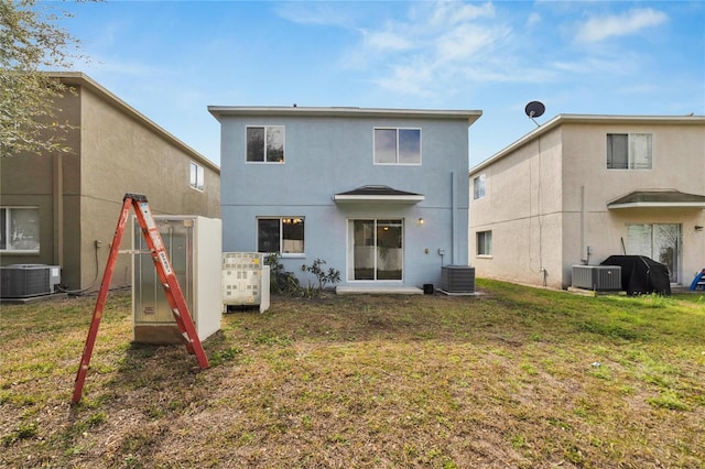 rear view of house with a lawn and cooling unit