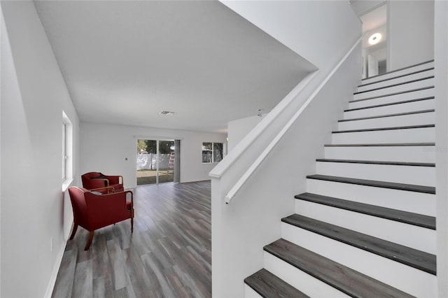 stairway featuring wood-type flooring