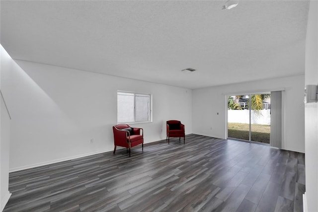 unfurnished room featuring a textured ceiling and hardwood / wood-style floors