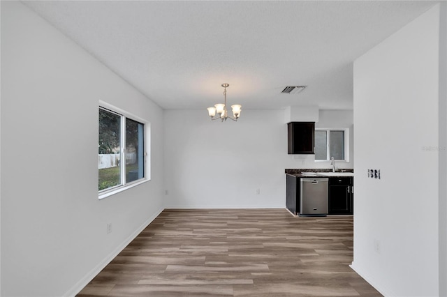 interior space with sink, a notable chandelier, and wood-type flooring