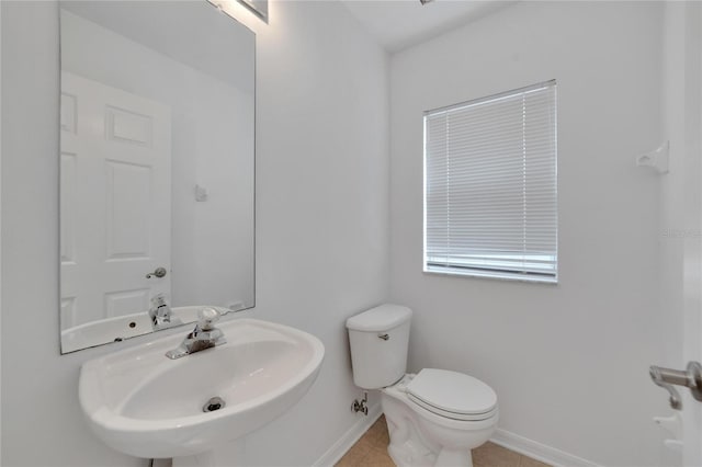 bathroom featuring sink, toilet, and tile patterned floors