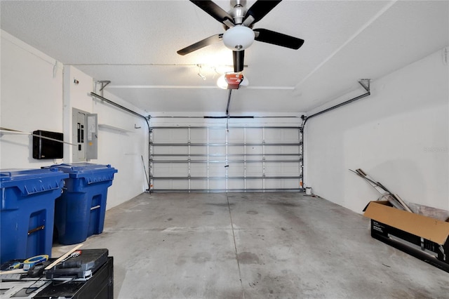 garage with ceiling fan, a garage door opener, and electric panel