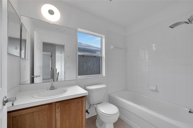 full bathroom with tile patterned flooring, vanity, tiled shower / bath combo, and toilet