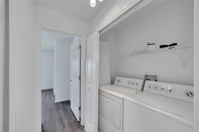 washroom featuring light hardwood / wood-style floors and washing machine and dryer