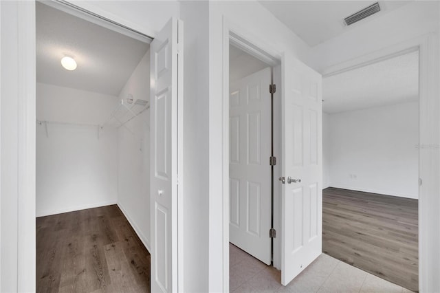 spacious closet with light hardwood / wood-style floors