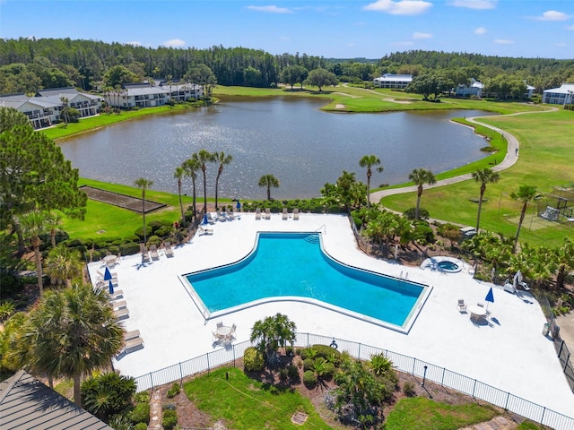 view of pool with a water view and a patio