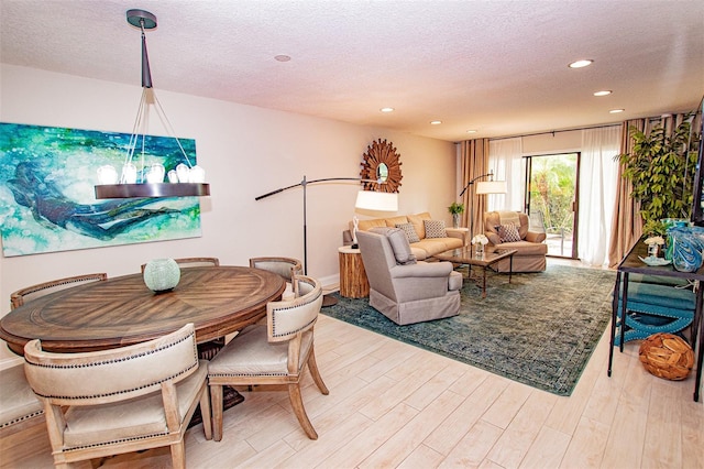 living room featuring a textured ceiling and light hardwood / wood-style flooring