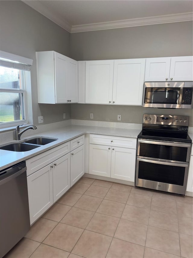 kitchen featuring white cabinetry, sink, crown molding, and appliances with stainless steel finishes