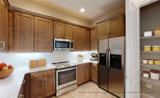 kitchen with stainless steel appliances, light tile patterned floors, and tasteful backsplash