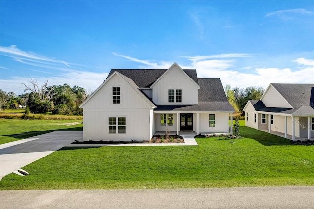 modern farmhouse style home with a front lawn