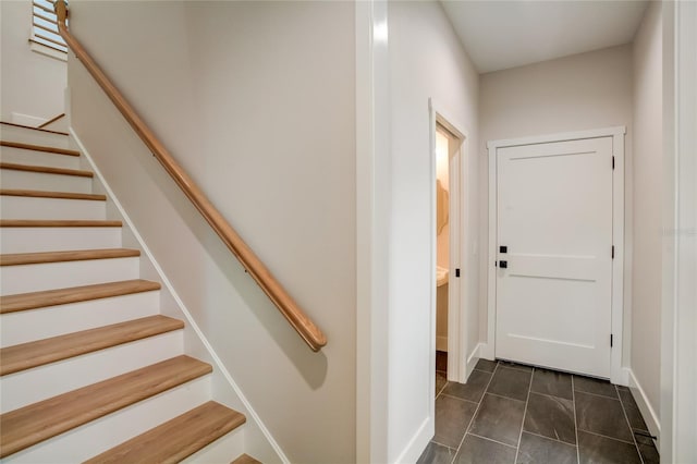 stairway with dark tile flooring