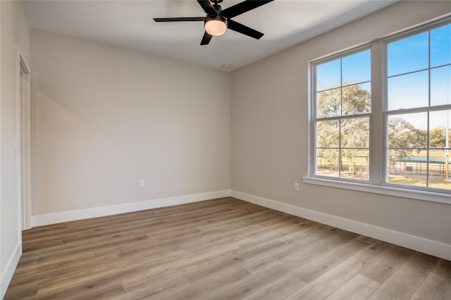 spare room featuring ceiling fan and light hardwood / wood-style flooring