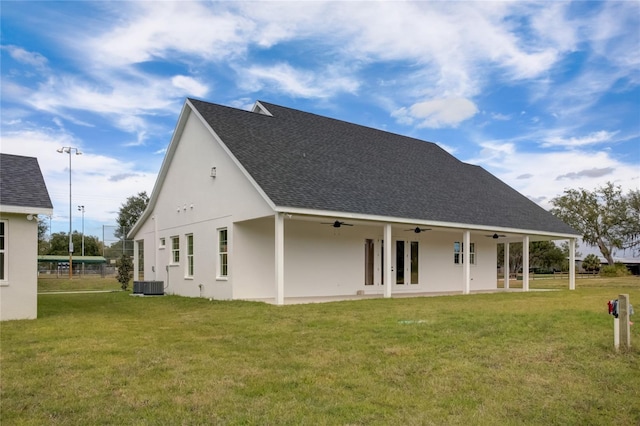 back of house featuring central AC unit, a yard, and ceiling fan