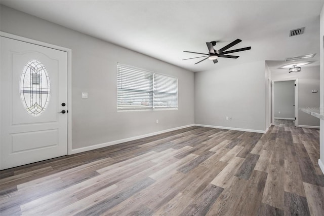 foyer featuring wood-type flooring and ceiling fan