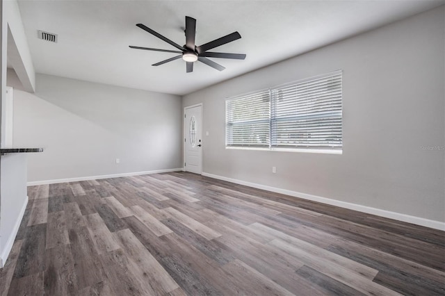 spare room featuring dark hardwood / wood-style flooring and ceiling fan