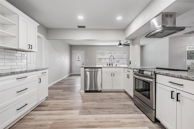 kitchen featuring light wood-type flooring, stainless steel appliances, ceiling fan, and white cabinetry