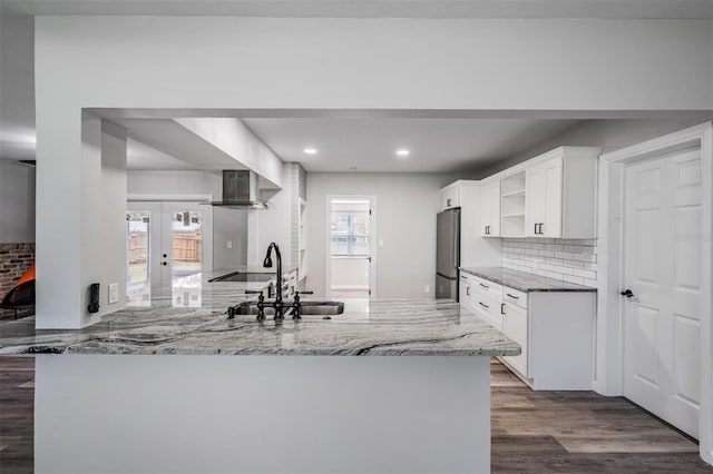 kitchen featuring french doors, sink, dark hardwood / wood-style flooring, light stone countertops, and tasteful backsplash