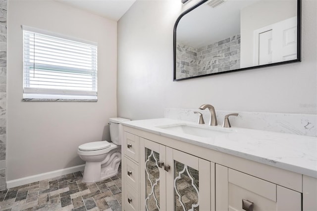 bathroom with tile floors, toilet, and vanity